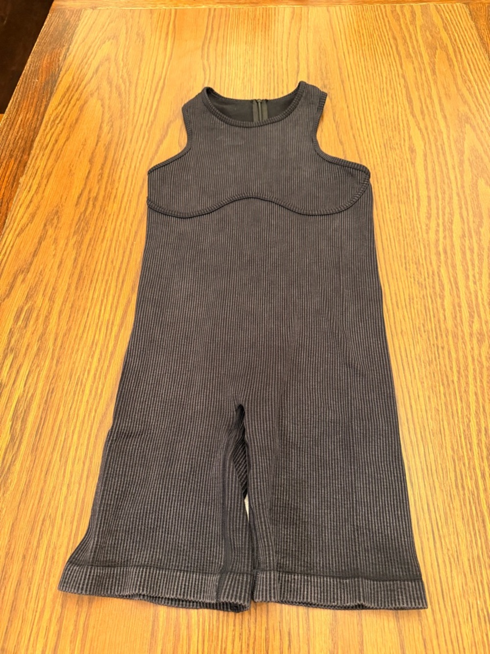 Ribbed athletic short romper with high neck. Zippered closure in back